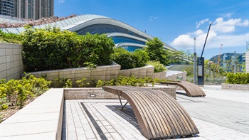 The wooden benches which cohere with the wavy design language of the building provide rest and view for the visitors.